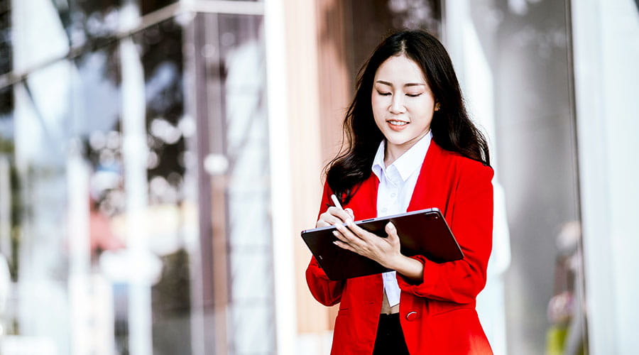 Businesswoman standing with folder in office Businesswoman standing with folder in office