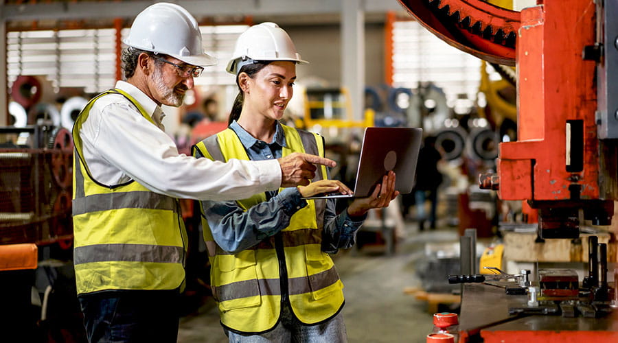Workers collaborating on manufacturing process Workers collaborating on manufacturing process