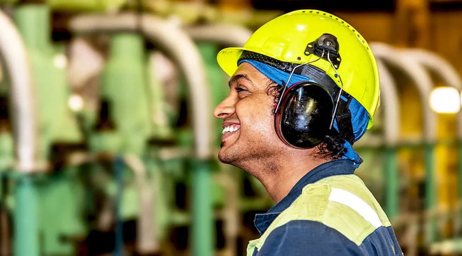 Worker wearing helmet in industrial environment Worker wearing helmet in industrial environment