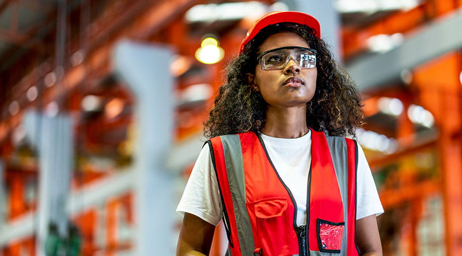 Engineer wearing safety vest in factory Engineer wearing safety vest in factory