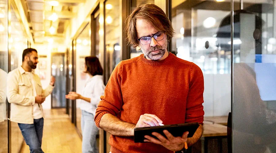 Person using tablet in office environment Person using tablet in office environment