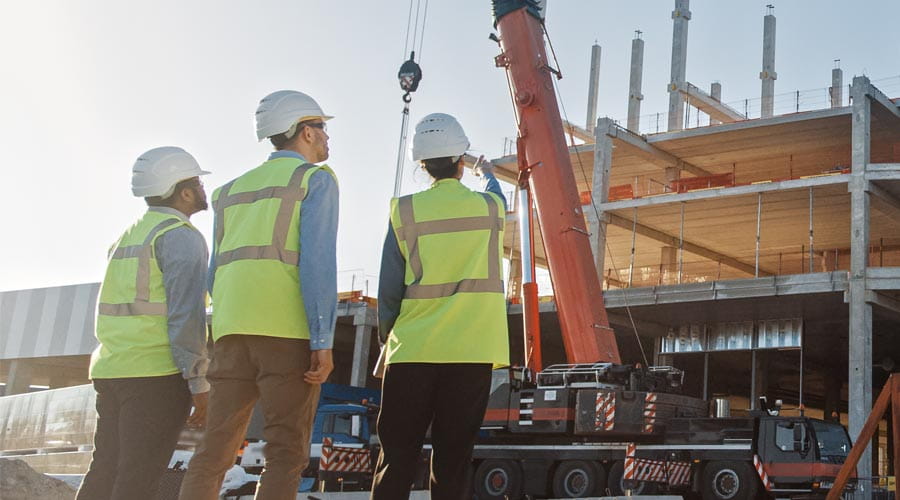 Construction project managers discussing tasks on site Construction project managers discussing tasks on site