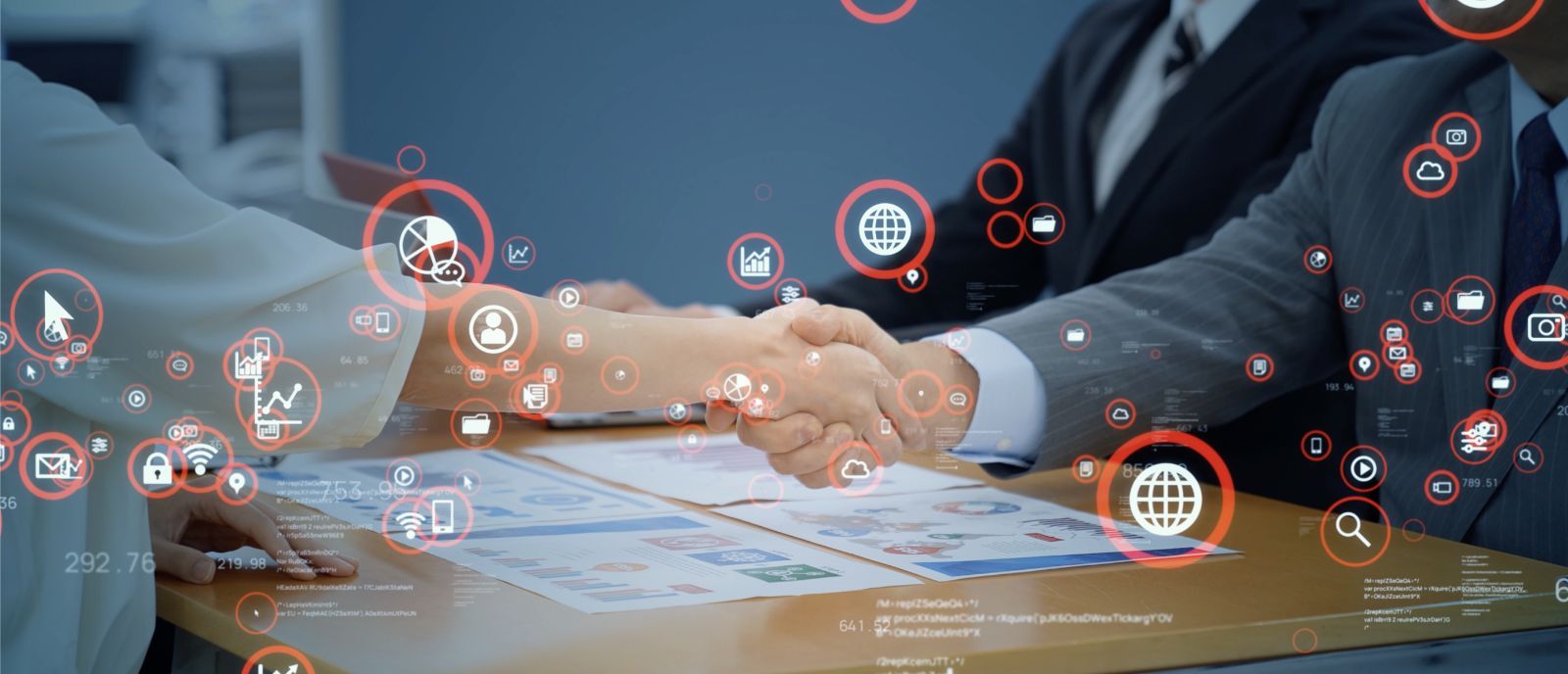 Business handshake over a table with charts and documents, surrounded by digital icons representing technology and data, symbolizing a tech-driven business deal